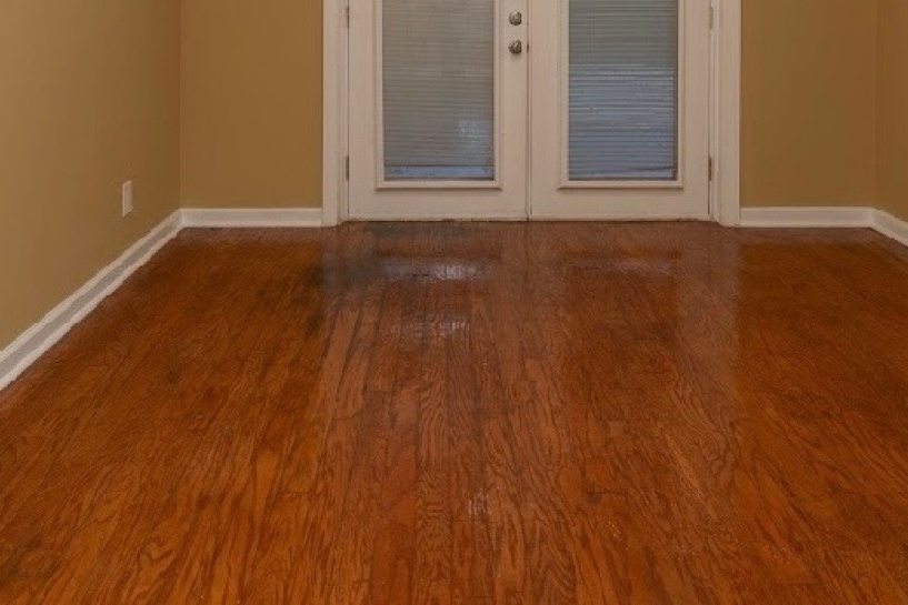 Refinished hardwood flooring with white baseboards