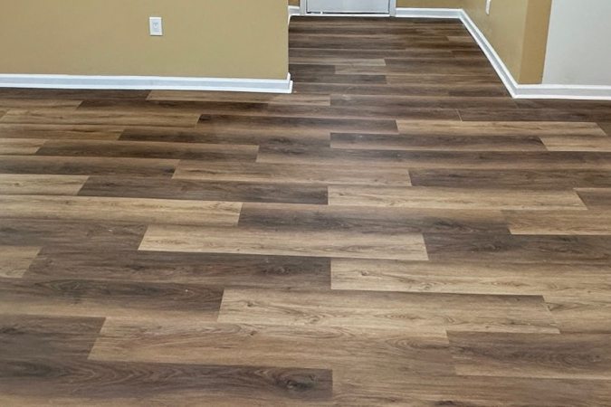 Wood-look vinyl plank running from a living room into a kitchen