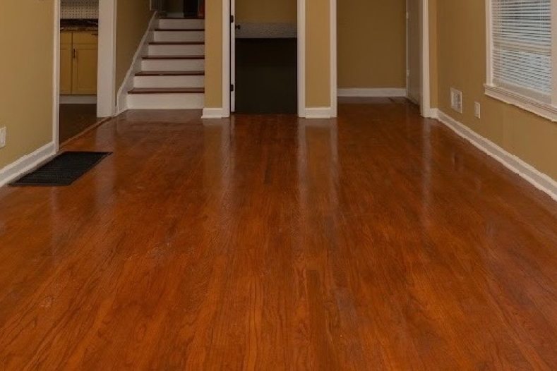 Refinished hardwood floor running into a stair hall