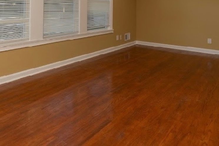 Warm refinished hardwood in a bright living room
